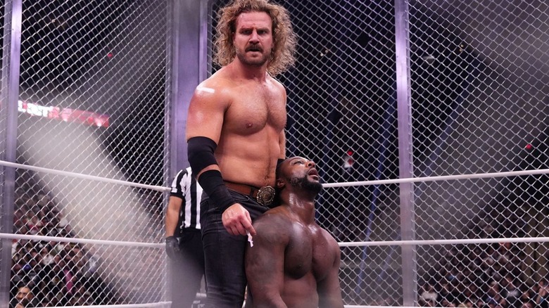 Hangman Adam Page holds up Swerve Strickland in their cage match at AEW All Out 2024
