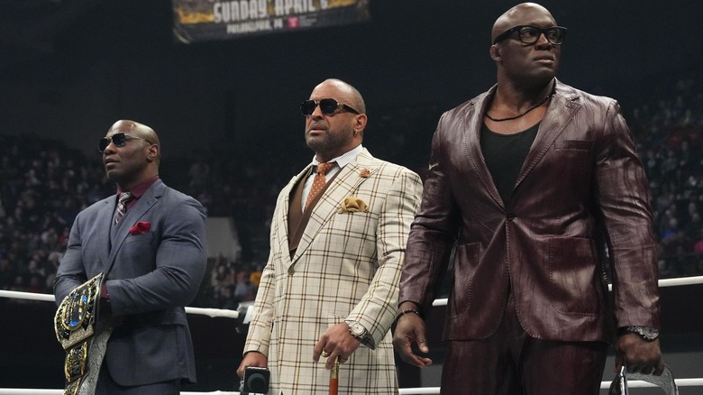 Shelton Benjamin, MVP, and Bobby Lashley standing in a ring