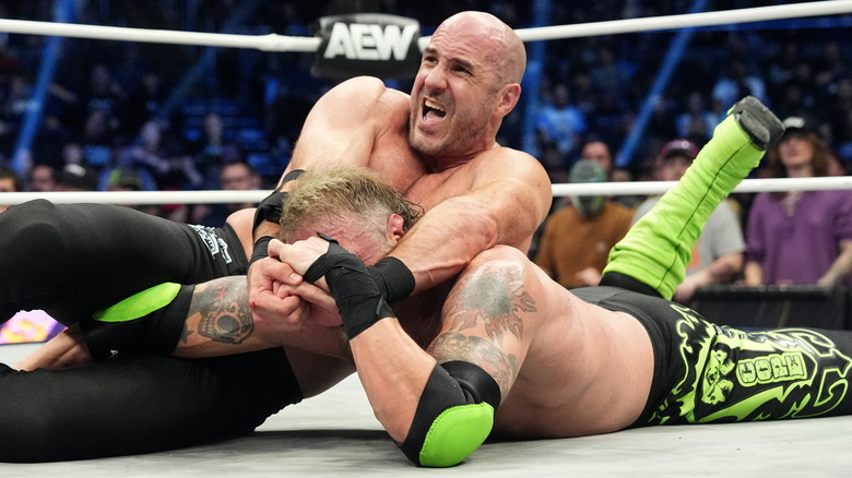 Claudio Castagnoli putting Adam Copeland in a submission hold