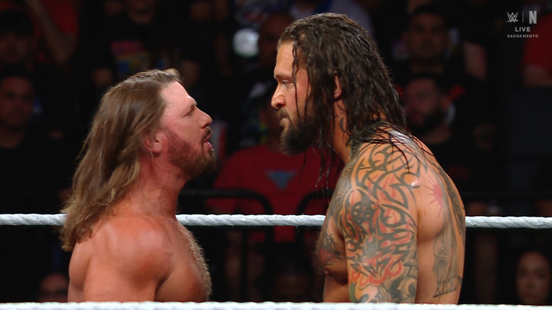 Styles and Kross staring each other down in the ring