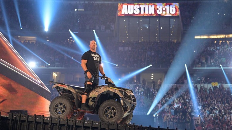 "Stone Cold" Steve Austin heads down the ring on a four-wheeler to confront Kevin Owens at WrestleMania 38.