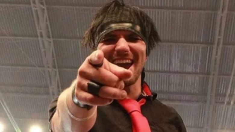 "Australian Suicide" Broderick Shepherd points and laughs at the camera taking his photo while standing in the ring during an event.