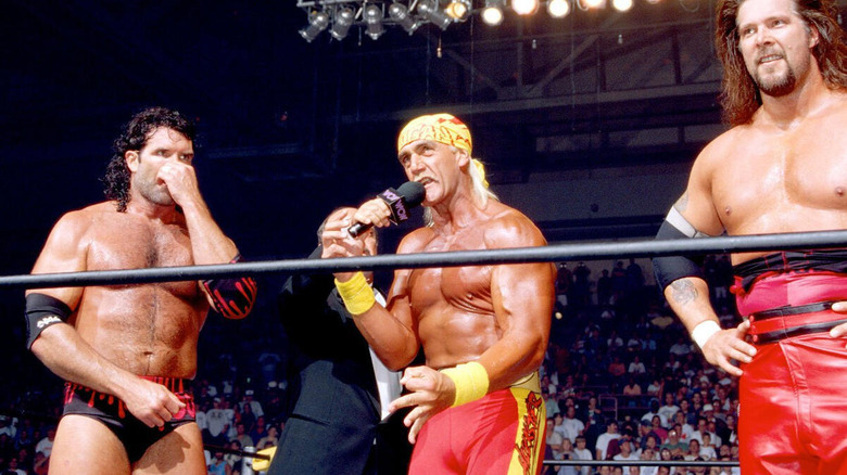 Hulk Hogan cuts a promo in the middle of the ring alongside Razor Ramon and Diesel after being revealed as the "third man" of nWo at Bash at the Beach in 1996.