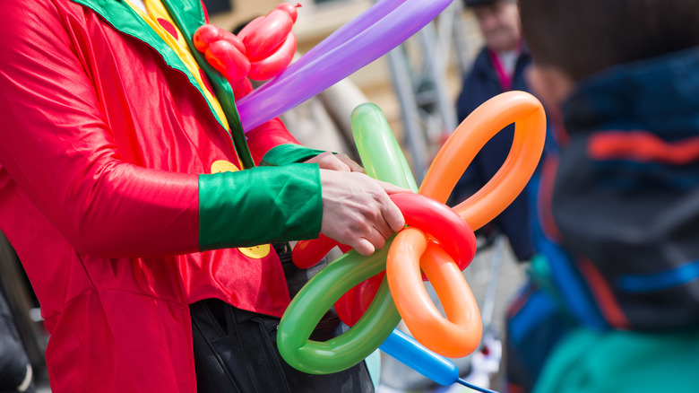 A clown makes balloon animals