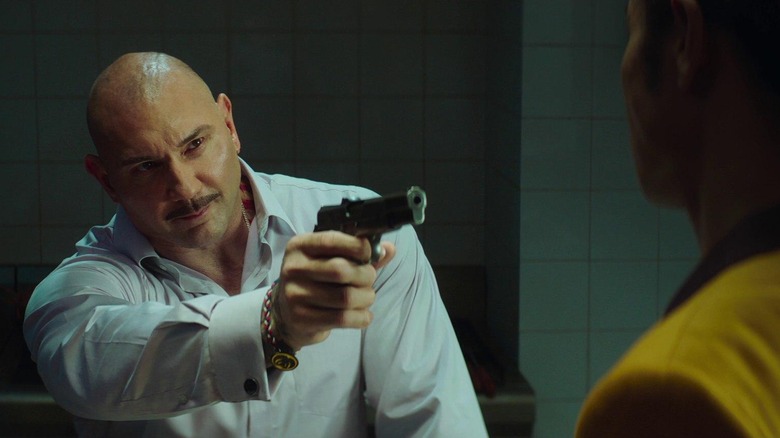 Owen Davidson points a gun