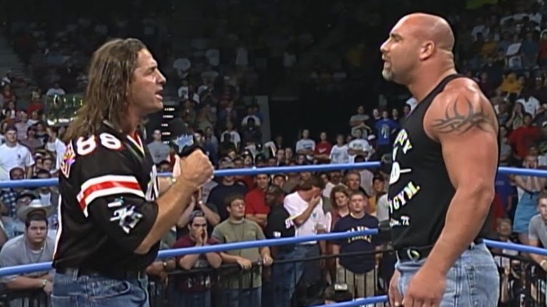 Bret Hart speaking to Goldberg in the ring