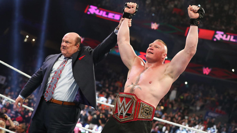 Paul Heyman raises Brock Lesnar's hand