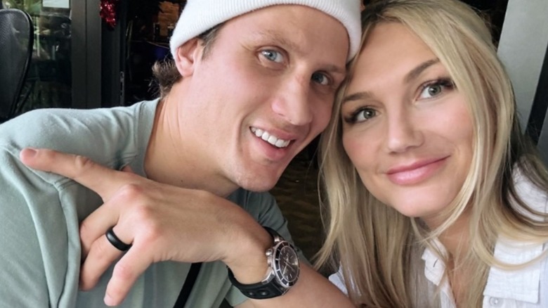 Brooke Hogan and husband Steve Olesky pose for the camera while seated at a restaurant in a photo posted to Hogan's Instagram account.