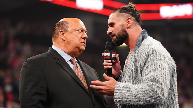 Paul Heyman and Seth Rollins talking in WWE ring