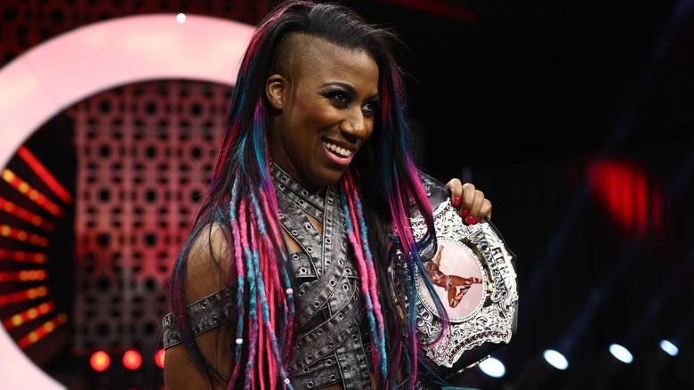 Athena grins, Ring of Honor Women's World Champion spinner title on her shoulder.