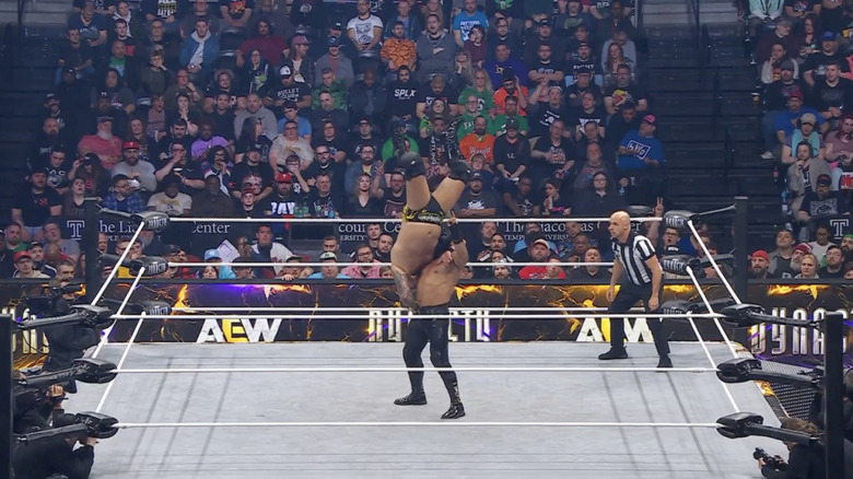 Bandido with Jericho up in a delayed vertical suplex