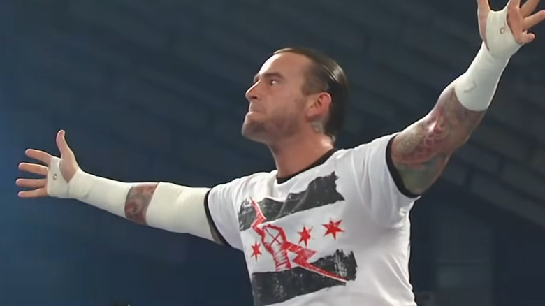 CM Punk extends arms