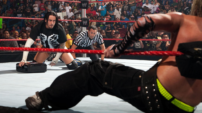 CM Punk kneeling wrestling ring