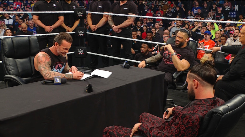 Punk, Reigns, and Rollins inside the ring