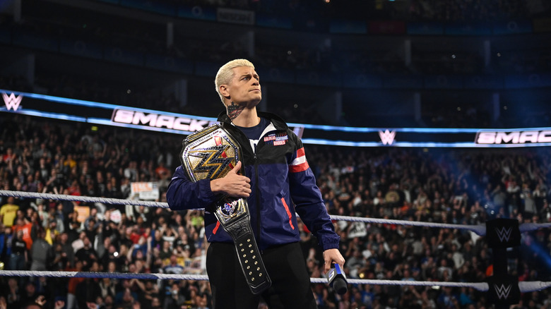 Cody Rhodes in the ring with his title and a mic