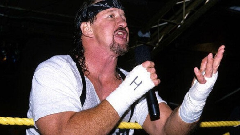 Terry Funk speaks into a microphone during a promo before a match.