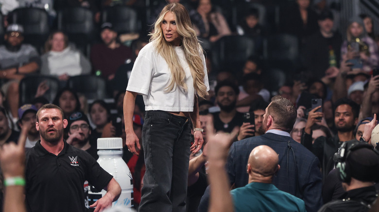 Charlotte Flair stands in the crowd on "WWE SmackDown"