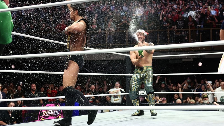 Katsuyori Shibata and Will Ospreay celebrate by popping champagne at the end of "AEW Dynamite"
