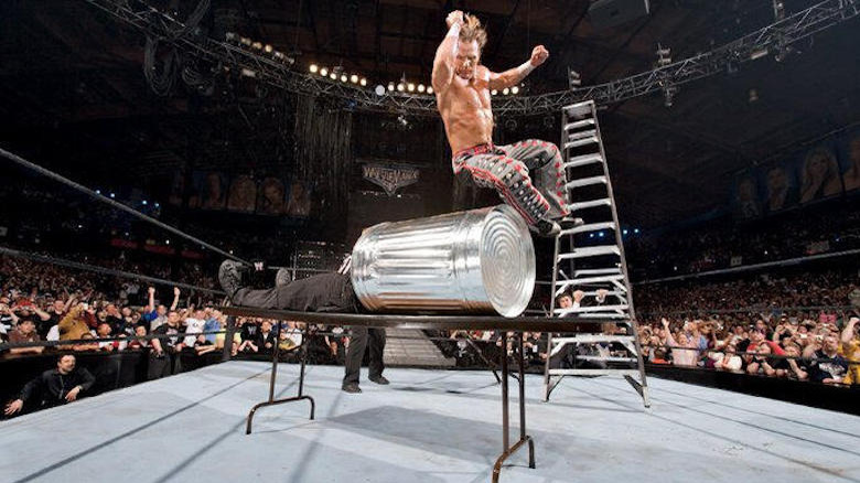 Shawn Michaels drops elbow off ladder through table with Vince McMahon on it inside garbage can at WrestleMania 22