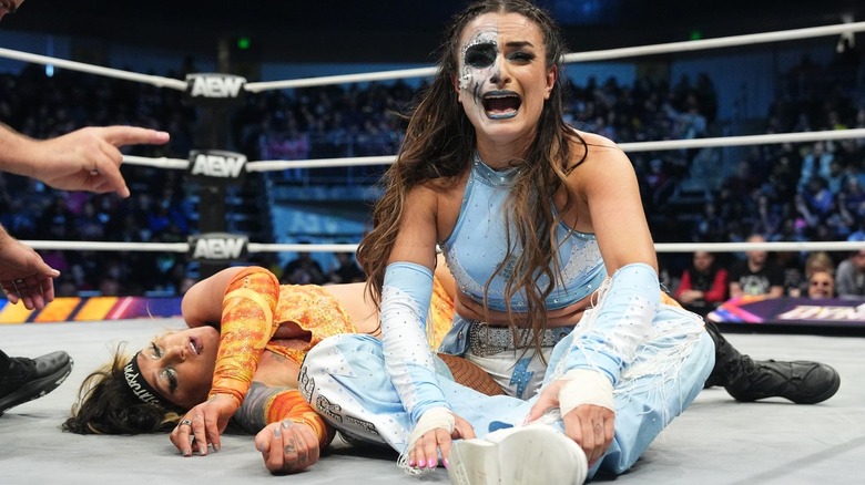 Thunder Rosa screams in frustration while sitting on the mat with Kris Statlander lying prone behind her on "AEW Dynamite"