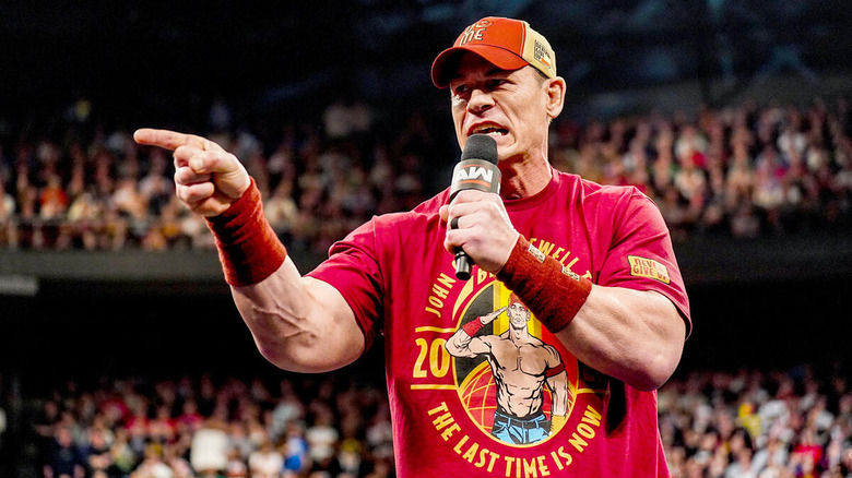 John Cena points while speaking on the microphone on "WWE Raw"