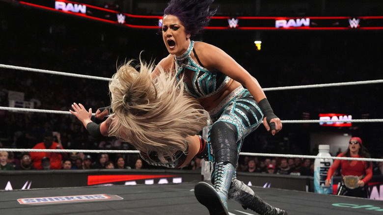 Bayley delivers a clothesline to Liv Morgan while Raquel Rodriguez looks on from outside the ring on "WWE Raw"