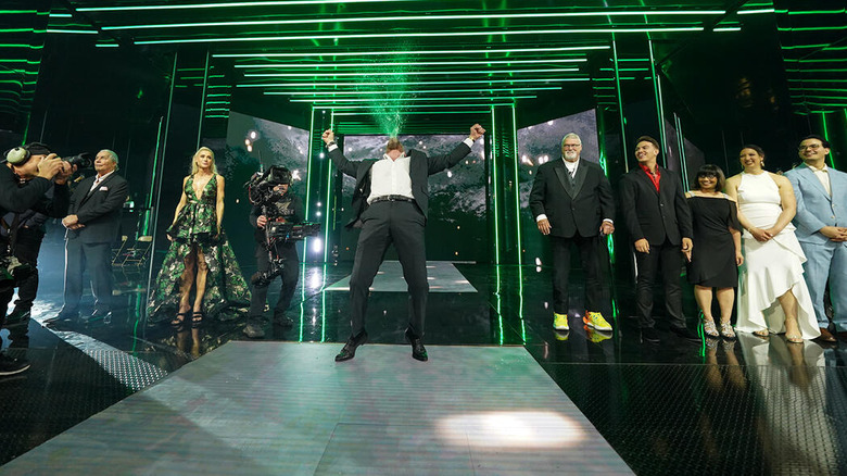 Triple H spiting water amidst the 2025 Hall of Fame inductees