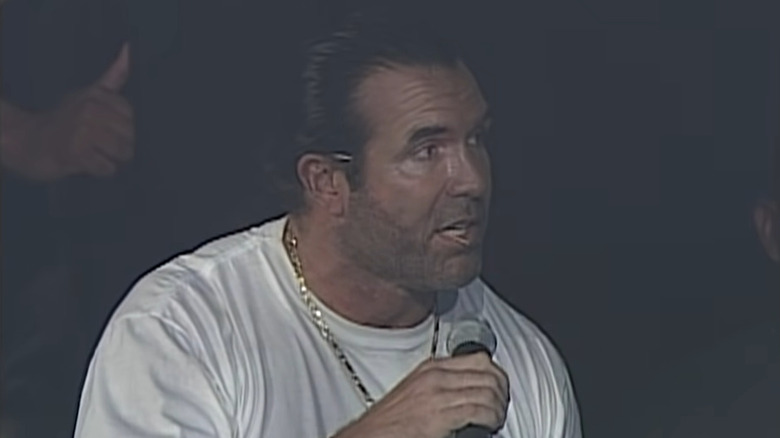 Scott Hall holds mic