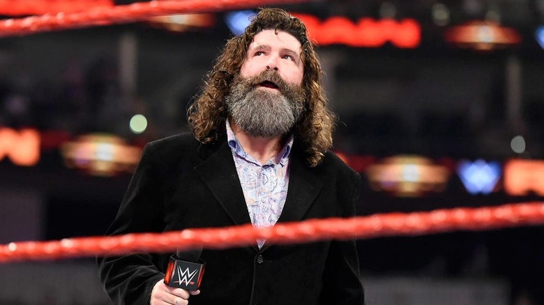 Mick Foley looks up at the fans in upper tier