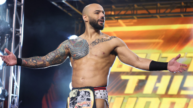 Ricochet poses on the stage before a Continental Classic match against Will Ospreay on "AEW Collision."