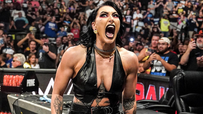 Rhea Ripley shouts as she travels around the outside of a "WWE Raw" ring.