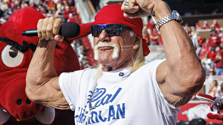 Hulk Hogan flexes in Real American Beer shirt