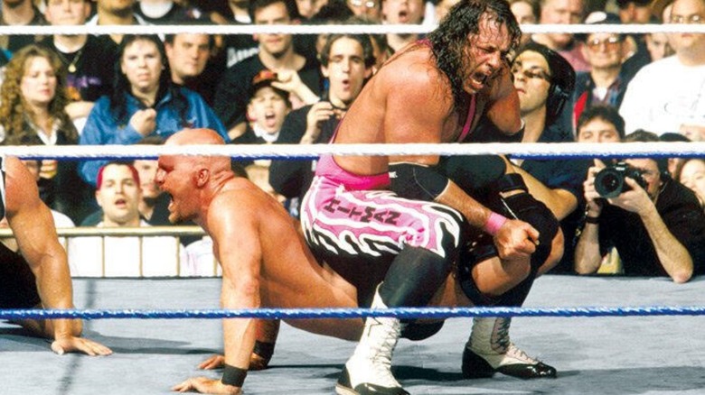 Bret Hart holds Steve Austin in a sharpshooter