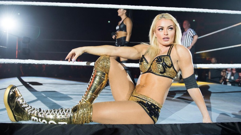 Mandy Rose posing on the ring apron