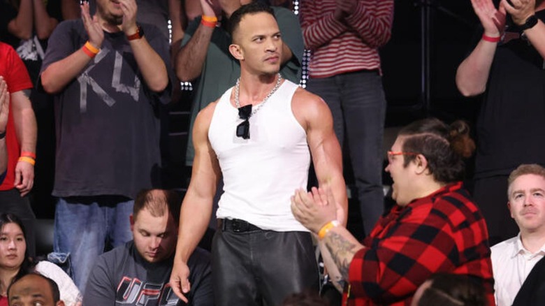 Ricky Saints stands in the crowd of the WWE Performance Center while making his "WWE NXT" debut the day after his AEW release.