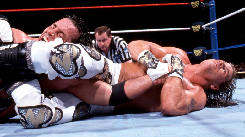 Shawn Michaels attempts to force Bret Hart to tap out to an armbar.