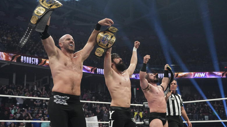 The Death Riders hold up the AEW World Trios Championship belts