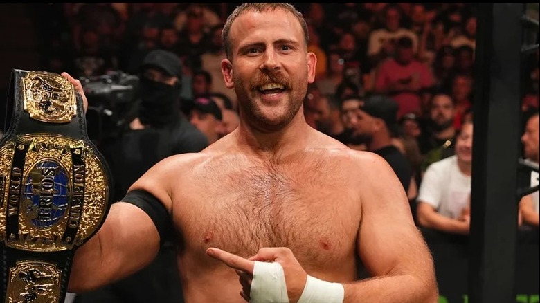 Mark Davis smiles proudly after stealing the AEW World Trios Championship