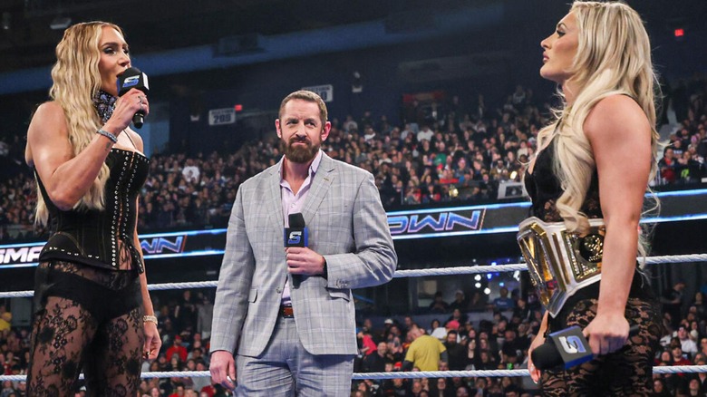 Charlotte Flair and Tiffany Stratton during their promo battle, whilst Wade Barrett stands between them. WWE 