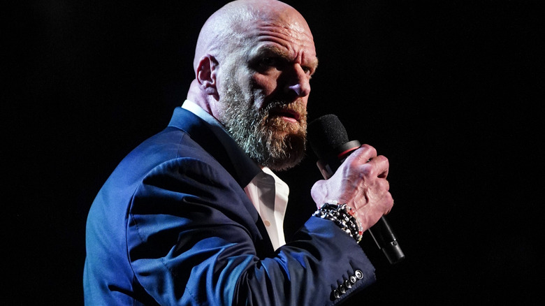 Paul Levesque speaking into a microphone