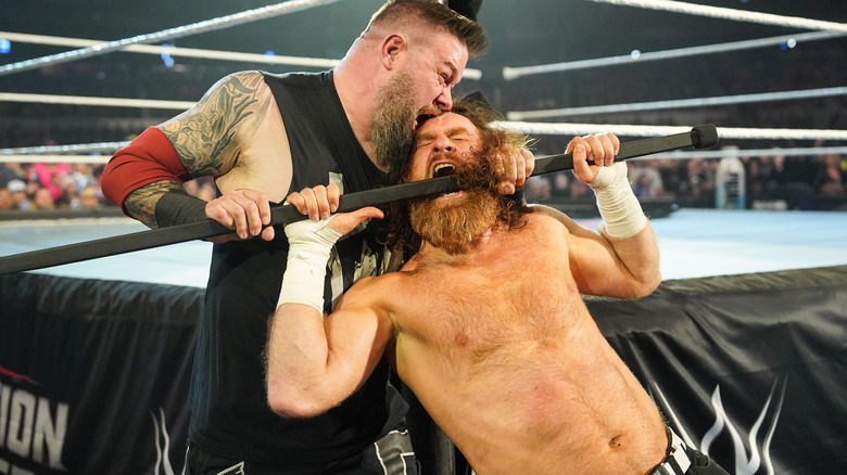 Kevin Owens choking and biting Sami Zayn at WWE Elimination Chamber
