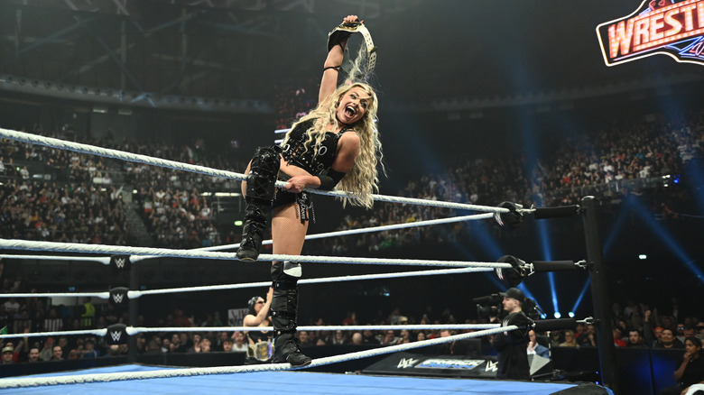 Morgan holding up her Women's Tag Team Championship belt