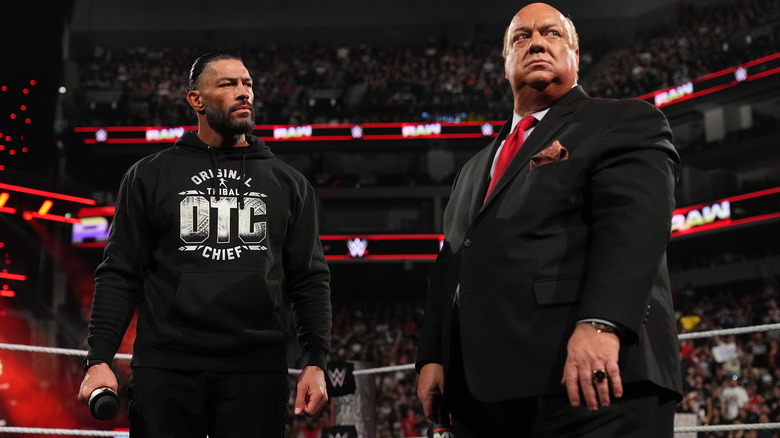 Roman Reigns staring at an uncomfortable Paul Heyman in the ring on "WWE Raw"
