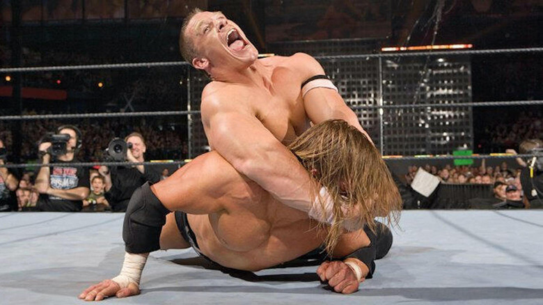 John Cena with the STFU on Triple H in the middle of the ring at WrestleMania 22