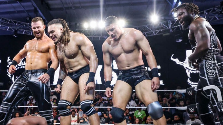 Darkstate stands tall over an opponent after a match on "WWE NXT."