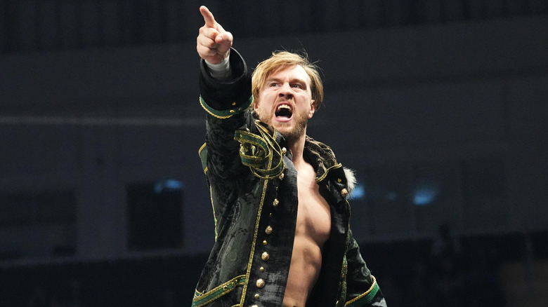 Will Ospreay points to the All in Texas advertisement in the arena while standing on the turnbuckle before a match on "AEW Dynamite."