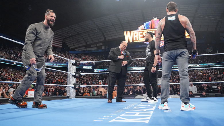 Seth Rollins, Paul Heyman, Roman Reigns, and CM Punk in the ring on "WWE SmackDown"