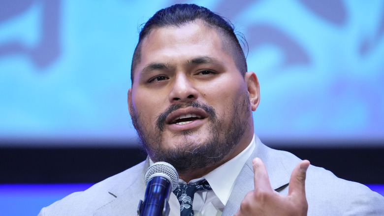 Jeff Cobb wearing a suit and pointing at himself
