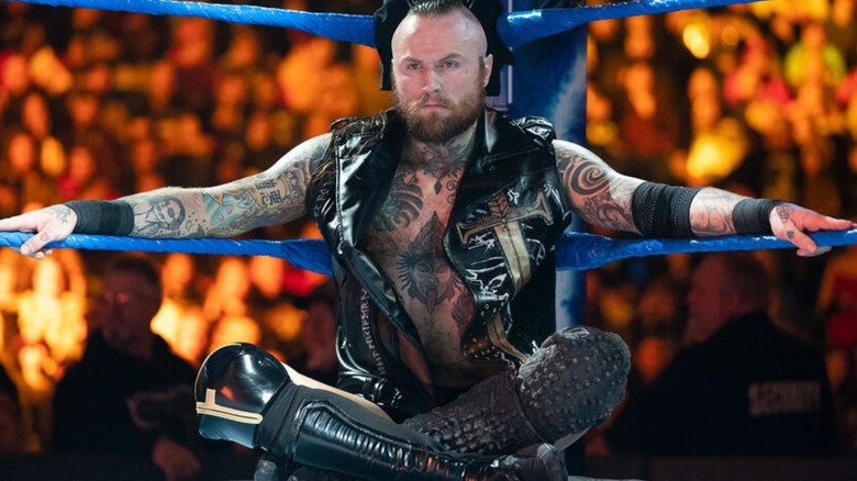 Aleister Black sits in the corner, staring off into the distance, before a match on "WWE SmackDown."