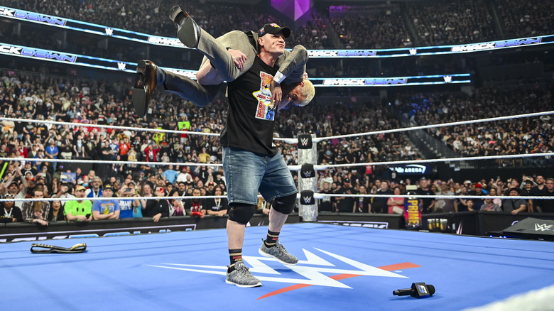 John Cena with Cody Rhodes on his shoulders in position for an Attitude Adjustment on 